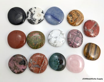 May include: Assortment of 14 smooth, polished, round, flat stones in various colours and patterns. The stones are arranged in three rows on a white surface.
