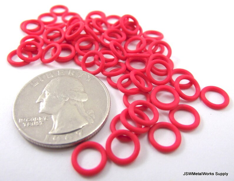May include: A pile of bright pink rubber O-rings, approximately the size of a US quarter.