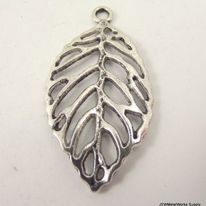 May include: Silver-toned metal leaf charm with a delicate, openwork design. The charm has a loop at the top for attaching to jewelry or other crafts.