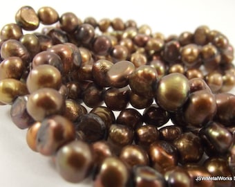 May include: A strand of brown freshwater pearls with a slightly iridescent sheen. The pearls are irregular in shape and have a natural, organic look.