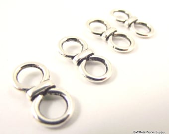 May include: Silver-toned metal figure eight jump rings. The rings are smooth and have a slightly rounded shape. They are ideal for jewelry making and other crafts.