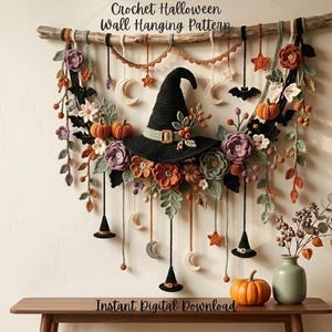 May include: A crochet Halloween wall hanging pattern featuring a central black witch hat surrounded by orange pumpkins, purple and orange flowers, green leaves, black bats, and white crescent moons suspended from a wooden branch with hanging charms.
