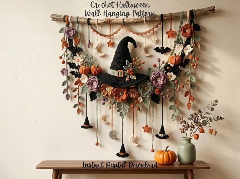 May include: A crochet Halloween wall hanging pattern featuring a central black witch hat surrounded by orange pumpkins, purple and orange flowers, green leaves, black bats, and white crescent moons suspended from a wooden branch with hanging charms.