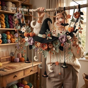 May include: A decorative wall hanging featuring a central black crocheted witch hat surrounded by crocheted flowers, pumpkins, crescent moons, stars, and bats. The elements are suspended from a natural wooden branch with various yarn strands.