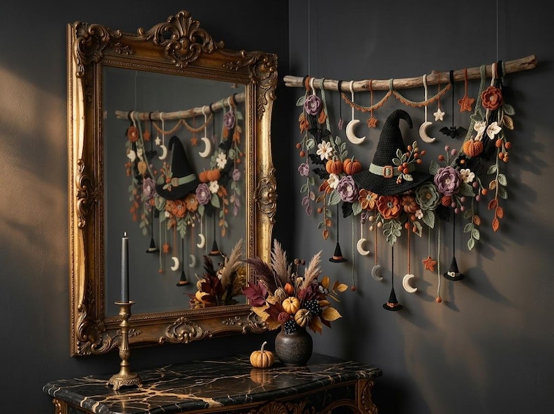 May include: A wall hanging featuring a black witch hat, crocheted flowers, pumpkins, and crescent moons suspended from a wooden branch. The display includes small hanging witch hats, stars, and bats, with a mirror reflecting the arrangement.