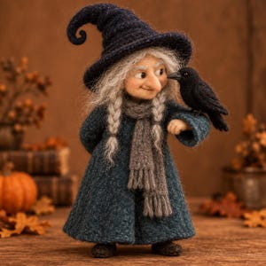 May include: A needle-felted witch figurine wearing a dark blue pointed hat, a matching long coat, and a grey scarf. The figure has long grey hair in two braids and a large nose. A small black crow is perched on the figure's left arm.