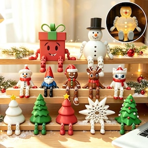 May include: A collection of articulated holiday figurines including a red gift box, a white snowman, a gingerbread person, a reindeer, a cat, and various Christmas trees, all featuring jointed limbs and sitting on wooden shelves.