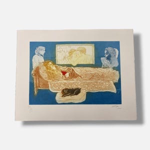 May include: A multi-colored etching on paper featuring a central figure reclining on a patterned couch with a small dark animal on a cushion below. The scene includes two side figures, a framed image of a couple, and a signature in the bottom right.
