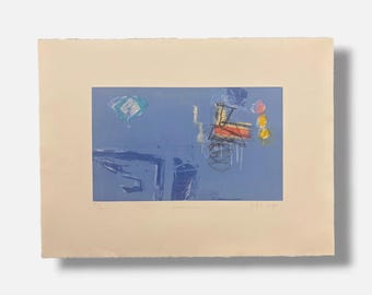 May include: A rectangular art print on cream paper featuring a blue background with abstract markings. The composition includes a central cluster of black lines, red and yellow shapes, and a small teal square. Handwritten text appears below the image.