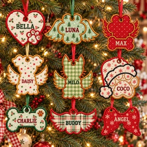 May include: A collection of nine embroidered Christmas ornaments in various shapes including hearts, wings, and bones. Each ornament features a name: Bella, Luna, Max, Daisy, Milo, Coco, Charlie, Buddy, and Angel, with festive patterns.