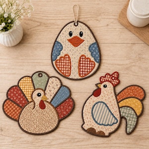 May include: Three fabric pot holders featuring quilted designs of a duck, a turkey, and a rooster. Each piece is crafted with various patterned fabrics in shades of blue, red, orange, and beige, finished with dark brown stitched edges.