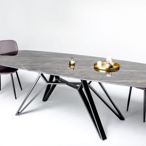 Handmade metal dining table frame with a distinctive modern design, created for rectangular wooden and stone tabletops. Durable steel construction, precision-finished welds and adjustable feet provide strong and stable support for custom tables.