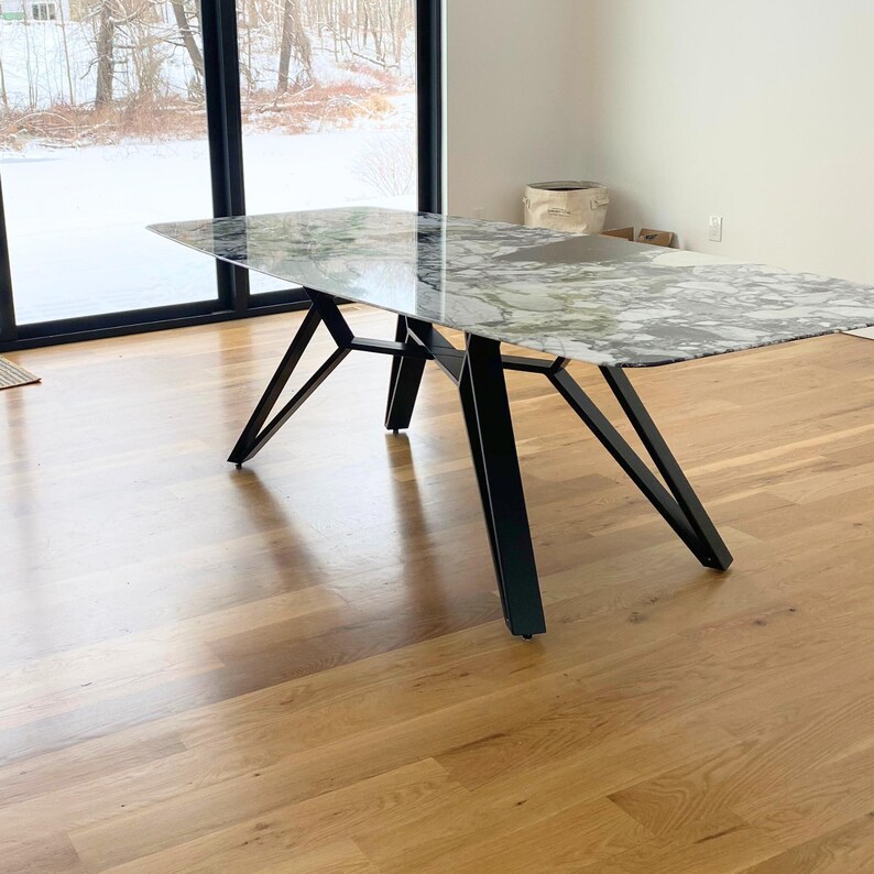 Heavy duty metal table base designed for a rectangular dining table top, featuring a unique contemporary shape and sturdy steel construction. Handmade furniture frame suitable for wooden, stone, marble and custom tabletops.