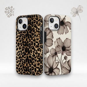 May include: Two smartphone cases are displayed side by side. The left case features a brown and black leopard print pattern. The right case has a cream background with a repeating pattern of large, translucent, dark grey floral illustrations.