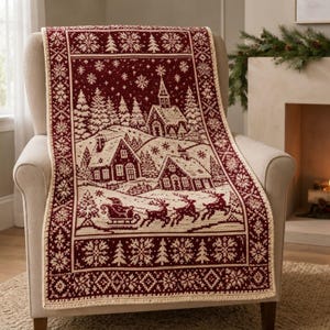 May include: A rectangular throw blanket featuring a deep red and cream color scheme with a woven winter scene. The design displays a snowy village with houses, a church, pine trees, and a sleigh pulled by reindeer, framed by snowflake borders.