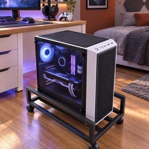 May include: A white computer tower case with a transparent side panel revealing internal components and glowing blue and purple lights, mounted on a black metal rolling stand with four caster wheels and a mesh front panel for ventilation.