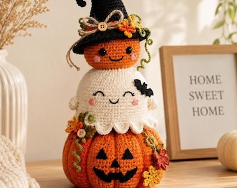 May include: A stacked crochet Halloween decoration featuring a large orange jack-o'-lantern base, a white ghost in the middle, and a small orange pumpkin wearing a black witch hat on top. The piece is adorned with small wooden buttons and fabric leaves.