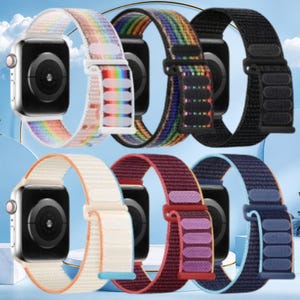 May include: Six nylon watch straps for smartwatches, arranged in two rows. The top row features a rainbow gradient, a dark rainbow stripe, and a solid black strap. The bottom row shows a cream, a deep maroon, and a dark navy blue strap.
