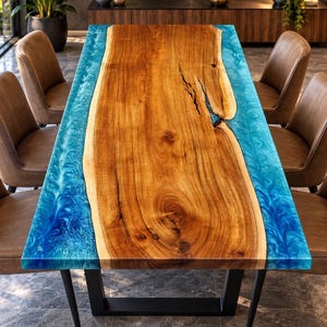 May include: A rectangular dining table featuring a natural live-edge wood slab center with prominent grain patterns and a deep crack, flanked by vibrant, swirling blue resin edges. The table is supported by a black metal frame and six chairs.