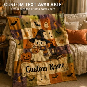 May include: A plush throw blanket featuring a patchwork design with Halloween motifs including ghosts, bats, pumpkins, and a lantern. A central ghost wears a witch hat and scarf while holding a mug. The text reads CUSTOM TEXT AVAILABLE and Custom Name.