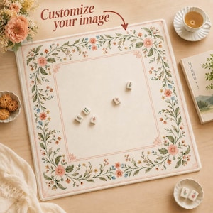 May include: A square mahjong mat with a cream-coloured centre and a border featuring a floral vine pattern in shades of pink, green, and blue. The mat includes the text "Customize your image" with an arrow pointing to the centre. Four small white mahjong tiles are placed on the surface.