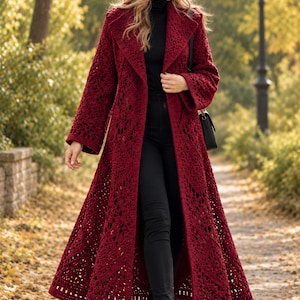 May include: A deep red, long-length crochet coat featuring an openwork diamond pattern, wide sleeves, and a large collar. The coat is paired with a matching red knit beanie with a pom-pom, a black turtleneck sweater, black trousers, and black boots.