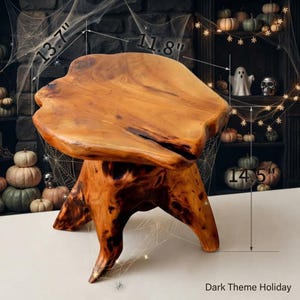 May include: A natural wood stool with a polished, irregular live-edge top and a sturdy root-like base. The stool features dimensions of 13.7 inches by 11.8 inches for the top surface and a total height of 14.5 inches as indicated by labels.