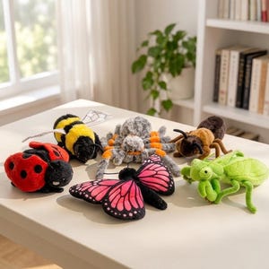 May include: A collection of six plush insect and arachnid toys including a red ladybird with black spots, a yellow and black bumblebee, a grey and orange spider, a brown beetle, a pink and black butterfly, and a bright green praying mantis.