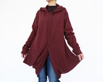 May include: A maroon hooded cardigan with a button-up front and long sleeves. The cardigan is worn over blue jeans and black heeled shoes.