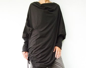 May include: A black, long-sleeved, draped tunic top with a gathered detail at the side. The top is paired with gray, loose-fitting pants.