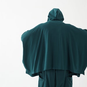May include: A teal hooded garment with a long, flowing design. The garment is made of a soft, comfortable fabric and has a relaxed fit.