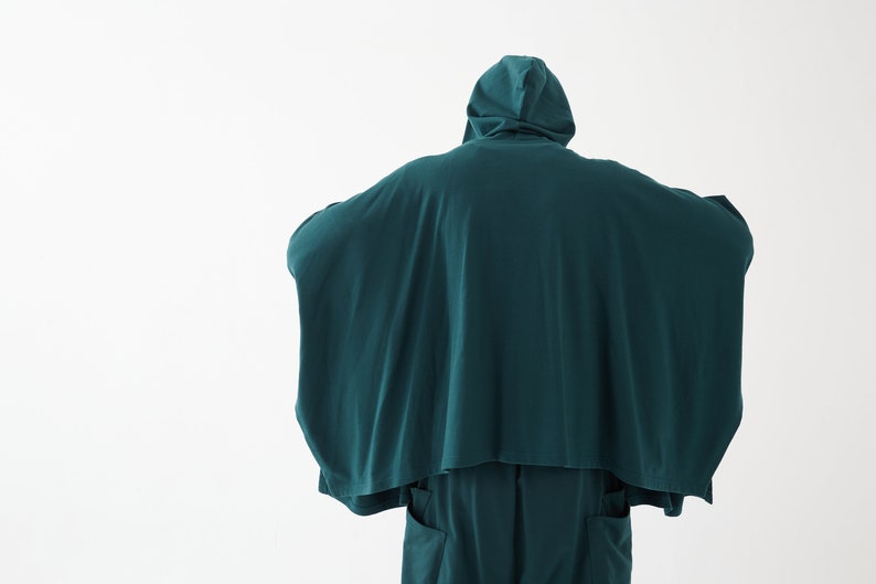 May include: A teal hooded garment with a long, flowing design. The garment is made of a soft, comfortable fabric and has a relaxed fit.