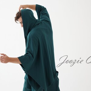 May include: A teal hooded robe with long sleeves. The robe is made of a soft, comfortable fabric. The text "Joozie Cotton" is visible in the lower right corner of the image.