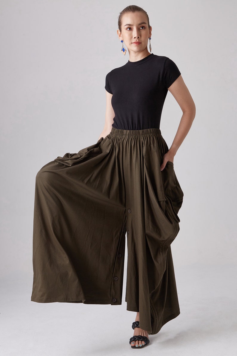 May include: A dark green, flowy, wide-leg pant with a button-up front and a gathered waist.