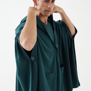 May include: A dark green hooded robe with a button closure and a pocket on the front. The robe is made of a soft, comfortable fabric.