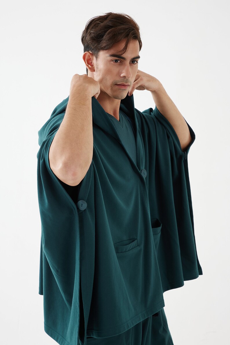 May include: A dark green hooded robe with a button closure and a pocket on the front. The robe is made of a soft, comfortable fabric.