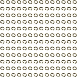 May include: A large collection of small, circular metal jump rings arranged in a uniform grid pattern. Each individual ring features a metallic bronze finish and a single split opening, designed for connecting jewellery components or craft projects.