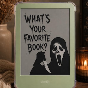 May include: A light green e-reader case featuring a graphic of a masked figure in a black hooded robe holding a knife. The screen displays the text "WHAT'S YOUR FAVORITE BOOK?" in a jagged, dark font. The case has a clear, protective border.
