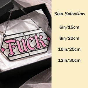 May include: A hexagonal hanging sign with a black frame and a chain, featuring the word FUCK in pink lettering against a white, textured background. The text Size Selection lists options of 6in/15cm, 8in/20cm, 10in/25cm, and 12in/30cm.