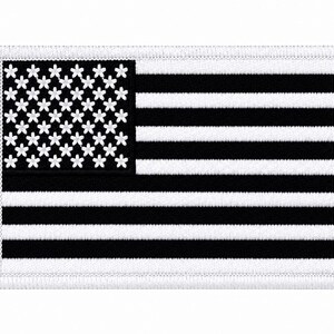 May include: A rectangular embroidered patch featuring a black and white American flag design. The canton displays white five-petaled flower shapes instead of stars, and the field consists of alternating horizontal black and white stripes.