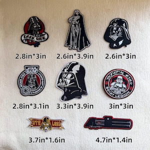 May include: A collection of eight embroidered patches featuring Star Wars characters and symbols, including Darth Vader, a Stormtrooper, and a lightsaber. Each patch is labeled with its dimensions in inches, ranging from 2.6in*3in to 4.7in*1.4in.