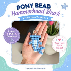 May include: A digital graphic for a Pony Bead Hammerhead Shark Keychain Tutorial. The text reads PONY BEAD Hammerhead Shark Keychain Tutorial, Instant PDF Download, and Your Next Craft Project. It features a light blue and white beaded shark.