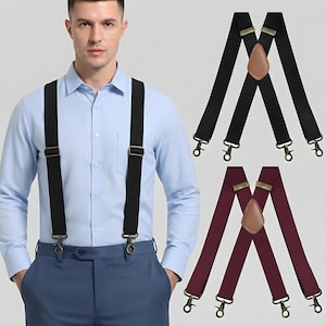 May include: A set of elastic suspenders featuring black and burgundy color options. Each pair has an X-back design with a brown leather-like patch at the center, adjustable metal sliders, and antique brass-toned metal swivel hook clips.