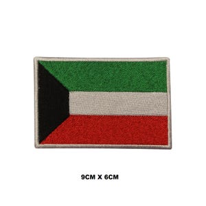 May include: A rectangular embroidered patch featuring the flag of Kuwait with a black trapezoid on the left and horizontal green, white, and red stripes. The patch measures 3.54 inches by 2.36 inches as indicated by the text 9CM X 6CM below it.