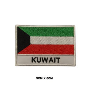 May include: A rectangular embroidered patch featuring the flag of Kuwait with horizontal green, white, and red stripes and a black trapezoid on the left. Below the flag, the word KUWAIT is stitched in black on a white background. Size 9cm x 6cm.