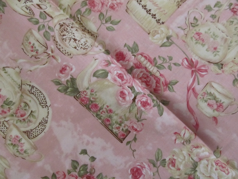 Pu&ograve; includere: Tessuto rosa con un motivo ripetitivo di tazze da t&egrave;, teiere e rose. Il tessuto ha un'estetica vintage.