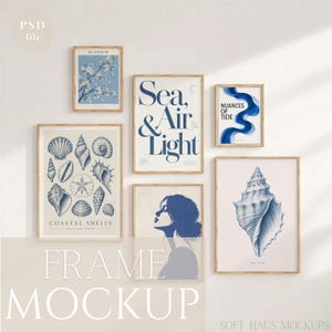 May include: A gallery wall set of six framed art prints featuring blue and white designs. The prints include illustrations of coastal shells, a profile of a person, a blue wave, cherry blossoms, and text reading Sea, Air & Light and Nuances of Tide.