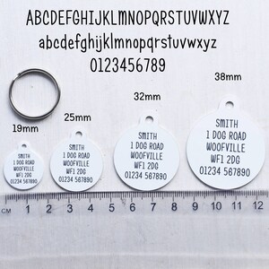 May include: Four white round dog tags with black text. The tags are 1.9 inches, 2.5 inches, 3.2 inches, and 3.8 inches in diameter. The text on the tags reads "SMITH 1 DOG ROAD WOOFVILLE WF1 2DG 01234 567890".