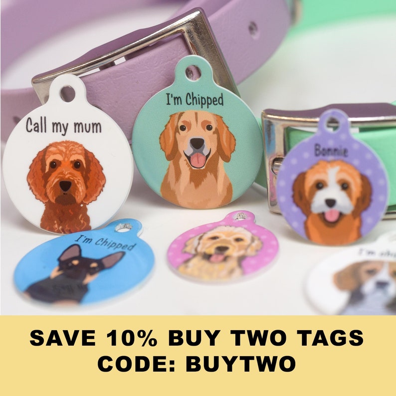 May include: A collection of colorful pet ID tags with dog illustrations. The tags feature various dog breeds and text such as "Call my mum" and "I'm Chipped". The background includes a dog collar.