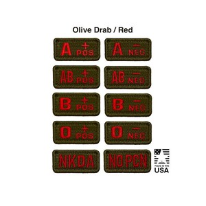 May include: A collection of rectangular olive drab embroidered patches with red lettering indicating blood types A, AB, B, and O, both positive and negative, plus NKDA and NO PCN labels. The text Olive Drab / Red appears at the top, with a Made in the USA logo.